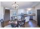 Bright kitchen boasts white cabinets, stainless steel appliances, and a center island with bar seating at 4063 S Meadow Wood Ct, New Palestine, IN 46163