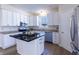 Well-lit kitchen featuring a dark island, stainless steel appliances, and ample white cabinetry at 4063 S Meadow Wood Ct, New Palestine, IN 46163
