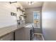 Organized laundry room with a folding counter, shelving, front load washer and dryer, and natural light at 4063 S Meadow Wood Ct, New Palestine, IN 46163