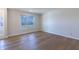 Sunlit living room with hardwood floors, large window, neutral walls, and natural light at 4063 S Meadow Wood Ct, New Palestine, IN 46163