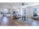 Bright living room featuring hardwood floors, a comfortable sofa, and an open layout at 4063 S Meadow Wood Ct, New Palestine, IN 46163