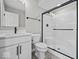 Modern bathroom features a sleek vanity, toilet, and glass-enclosed shower with matte black trim at 4180 Douro Trl, Westfield, IN 46062
