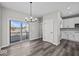 Stylish dining room with hardwood floors, a modern chandelier, and access to a balcony, perfect for elegant meals at 4180 Douro Trl, Westfield, IN 46062