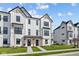 Newly built white townhome with black trim and welcoming front entrances framed by wooden posts at 4180 Douro Trl, Westfield, IN 46062