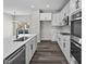 Modern kitchen featuring white cabinetry, sleek countertops, and stainless steel appliances for a gourmet cooking experience at 4180 Douro Trl, Westfield, IN 46062