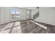 Sun-drenched living room with hardwood floors and a staircase, creating a welcoming atmosphere for relaxation and entertainment at 4180 Douro Trl, Westfield, IN 46062