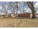 A fenced backyard with mature trees and view of the house, offering a serene outdoor space at 4808 N Tuxedo St, Indianapolis, IN 46205