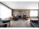 Spacious living room featuring a stone fireplace, cozy seating, and ample natural light at 4808 N Tuxedo St, Indianapolis, IN 46205