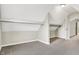 Attic space featuring carpet, storage shelves, and access to another room at 523 Terrace Ave, Indianapolis, IN 46203
