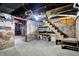 Unfinished basement with painted brick, storage shelving, and open space ready for your personal touch at 523 Terrace Ave, Indianapolis, IN 46203