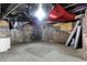 Spacious unfinished basement showing block foundation, concrete floor, and black ceiling at 523 Terrace Ave, Indianapolis, IN 46203