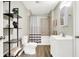 Bathroom featuring a vanity, toilet, shelving, and shower with tile surround at 523 Terrace Ave, Indianapolis, IN 46203