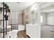 Bathroom featuring a vanity, toilet, shelving, and shower with tile surround at 523 Terrace Ave, Indianapolis, IN 46203