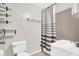 Modern bathroom featuring a shower with striped curtain and floating shelving at 523 Terrace Ave, Indianapolis, IN 46203