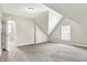 Attic bedroom with angled ceilings, plush carpeting, and an abundance of natural light at 523 Terrace Ave, Indianapolis, IN 46203