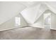 Bright attic bedroom with pitched ceilings, carpet, and a view to an adjacent room at 523 Terrace Ave, Indianapolis, IN 46203