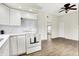 Open kitchen view into dining area featuring white appliances, cabinets, and updated flooring at 523 Terrace Ave, Indianapolis, IN 46203