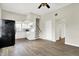 Open kitchen and living space with white cabinets, black appliances, and wood-look floors at 523 Terrace Ave, Indianapolis, IN 46203