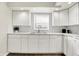 Bright kitchen featuring white cabinetry, marble backsplash, and stainless steel sink with a window view at 523 Terrace Ave, Indianapolis, IN 46203