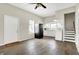 Cozy kitchen and living area with stairs, white cabinets, and black appliances at 523 Terrace Ave, Indianapolis, IN 46203