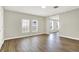Bright living room boasts wood-look floors and natural light from large windows at 523 Terrace Ave, Indianapolis, IN 46203