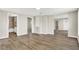 Open living space features wood-look floors and multiple doorways and natural light at 523 Terrace Ave, Indianapolis, IN 46203