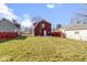 Spacious backyard featuring a well-maintained lawn and red picket fence, perfect for outdoor activities at 5334 E Burgess Ave, Indianapolis, IN 46219