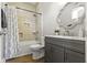 Bathroom features a gray vanity and shower and tub combo at 5334 E Burgess Ave, Indianapolis, IN 46219