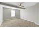Neutral bedroom featuring a ceiling fan, window, and plush carpeting at 5334 E Burgess Ave, Indianapolis, IN 46219
