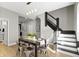 Dining room featuring a table for four and painted staircase at 5334 E Burgess Ave, Indianapolis, IN 46219