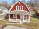 Charming two-story home with red siding, white trim, and a cozy covered front porch at 5334 E Burgess Ave, Indianapolis, IN 46219