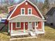 Charming two-story home with red siding, white trim, and a cozy covered front porch at 5334 E Burgess Ave, Indianapolis, IN 46219