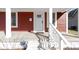 View of front porch with white railings leading to front door with sidelight at 5334 E Burgess Ave, Indianapolis, IN 46219