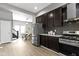 Open kitchen area boasts stainless steel appliances, dark cabinetry, and an attached dining area at 5334 E Burgess Ave, Indianapolis, IN 46219