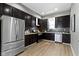 This kitchen features stainless steel appliances, dark cabinets, granite countertops, and subway tile backsplash at 5334 E Burgess Ave, Indianapolis, IN 46219