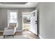 View from entry showing freshly painted living room with hardwood floors and lots of natural light at 5334 E Burgess Ave, Indianapolis, IN 46219
