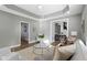 Beautifully staged living room with neutral colors, modern decor, and hardwood floors at 5334 E Burgess Ave, Indianapolis, IN 46219