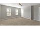 Spacious main bedroom with ceiling fan, two windows and plush carpeting at 5334 E Burgess Ave, Indianapolis, IN 46219