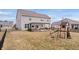 Backyard with a pergola covered patio, playset, and a black fence at 5646 Mahogany Dr, Noblesville, IN 46062