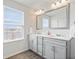 Bathroom with double vanity with stone countertop, framed mirror, and a window view of the lake at 5646 Mahogany Dr, Noblesville, IN 46062