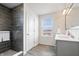 Beautiful bathroom features a stand up shower with sleek gray tiling and a double sink vanity at 5646 Mahogany Dr, Noblesville, IN 46062