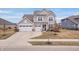 Attractive two-story home with a three-car garage and a well-maintained lawn on a sunny day at 5646 Mahogany Dr, Noblesville, IN 46062