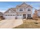 Charming two-story home with a three-car garage and well-manicured lawn in a suburban neighborhood at 5646 Mahogany Dr, Noblesville, IN 46062