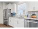Bright kitchen featuring stainless steel appliances, granite countertops, and modern white cabinets at 5646 Mahogany Dr, Noblesville, IN 46062