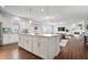 Open concept kitchen and living space with an island, white cabinets, and a dining area at 5646 Mahogany Dr, Noblesville, IN 46062