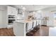 Spacious kitchen with an island, bar seating, stainless appliances, and modern pendant lighting at 5646 Mahogany Dr, Noblesville, IN 46062