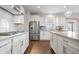 Modern kitchen featuring stainless steel appliances, an island, white cabinets, and granite countertops at 5646 Mahogany Dr, Noblesville, IN 46062