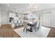 Bright kitchen and dining area with white cabinets, stainless appliances, and a wooden dining table at 5646 Mahogany Dr, Noblesville, IN 46062