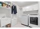 Well-organized laundry room with modern washer, dryer, sink, and plenty of storage space at 5646 Mahogany Dr, Noblesville, IN 46062