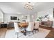 Open-concept living space with a fireplace, dining area, and view of the living room and television at 5646 Mahogany Dr, Noblesville, IN 46062